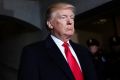 President-elect Donald Trump pauses as he waits to be introduced on the West Front of the U.S. Capitol on Friday, Jan. ...