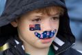 Tim Ford, 11, watches the WugulOra Morning Ceremony in honour of Australia's Traditional Custodians on Australia Day, at ...