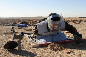 An Afghan de-miner searches for land mines in the Zhari district of Kandahar, Afghanistan on Monday, Jan. 9, 2017. After ...