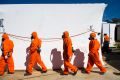 Asbestos workers prepare to remove Mr Fluffy loose-fill asbestos from a home in Kambah in April: Auditor Maxine Cooper ...