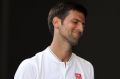 Novak Djokovic of Serbia reacts in his second round match against Denis Istomin of Uzbekistan.