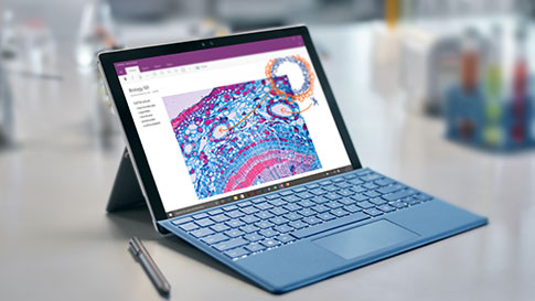 Surface Pro 4 with colorful OneNote page on screen, sitting on desk with Surface Pen