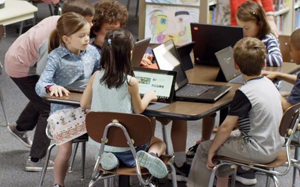 Picture of children using laptops in a classroom