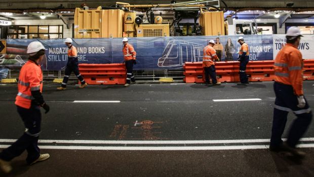 Workers on George Street after traffic was stopped for the last time as the light rail construction begins.