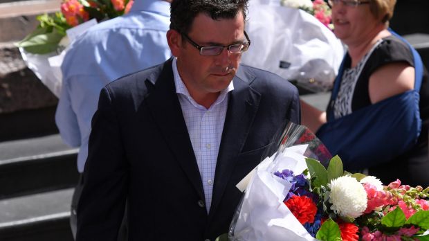 Premier Daniel Andrews lays flowers in the Bourke Street Mall on Saturday morning.