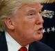 Vice President Mike Pence watches at left as President Donald Trump prepares to sign his first executive order in the ...