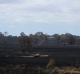 A fire truck refills from a dam inside Paul Davis' property after crews worked through the night on Wednesday to put out ...