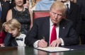 President Donald Trump prepares to formally sign his cabinet nominations into law.