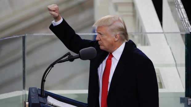 President Donald Trump pumps his fist after delivering his inaugural address.