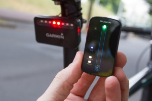 The Garmin system includes a radar tail-light transmitter and a head unit attached to the handlebars.