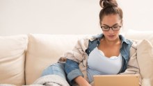 A woman demonstrates the new Willow breast pump.