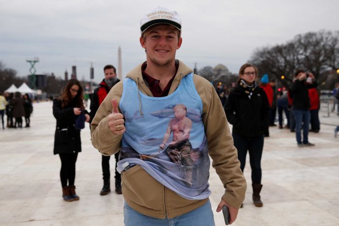 A Trump supporter stands in the foreground of the Washington Monument