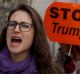 In Madrid, a women joins thousands at an anti-Trump march.