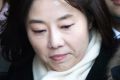 South Korean Culture Minister Cho Yoon-sun, center, leaves the Seoul Central District Court in Seoul after attending a ...