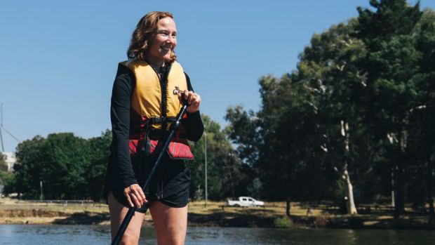 Angela Frimberger with her children Ivy and Alex Moore from Port Maquarie stand up paddle boarding on Lake Burley ...