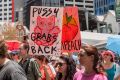 Hundreds braved a hot Brisbane morning to protest against the inauguration of Donald Trump.