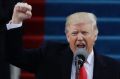 President Donald Trump pumps his fist after delivering his inaugural address.