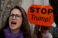 In Madrid, a women joins thousands at an anti-Trump march.
