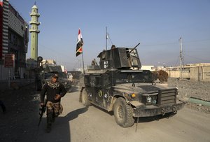 Iraq's special forces troops patrol in the eastern side of Mosul, Iraq, Thursday, Jan. 19, 2017 a day after declaring the area "fully liberated" from Islamic State militants.