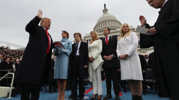 President Donald Trump takes the oath of office from Chief Justice John Roberts, as his wife Melania holds the Bible, ...