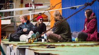 Scientists sit on the deck of the Akademik Treshnikov