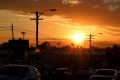 The sun rises over Parramatta Road in Sydney early Wednesday morning before the temperatures rise. 