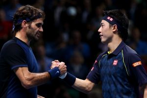 Roger Federer shakes hands with Kei Nishikori after his victory in their match at Barclays ATP World Tour Finals in 2015 ...