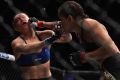 Brazilian Amanda Nunes punches Ronda Rousey in their UFC women's bantamweight championship bout.