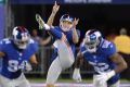 New York Giants' Australian punter Brad Wing (centre) is heading to the NFL play-offs.