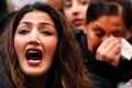 A demonstrator shouts during a protest against the deportation of Afghan asylum seekers at the airport in Frankfurt, ...