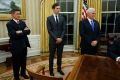 Jared Kushner, flanked by National Security Adviser Michael Flynn (left) and US Vice-President Mike Pence, watches his ...