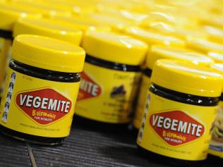 **FILE** An Oct. 24, 2013 file photo of Vegemite rolling along the production line at the Vegemite factory in Melbourne, Thursday, Oct. 24, 2013. Bega Cheese has agreed to buy brands including Australian icon Vegemite in a deal worth $460 million, Thursday, Jan. 19, 2017. (AAP Image/Julian Smith) NO ARCHIVING