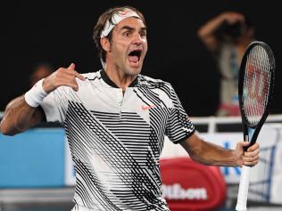 Switzerland's Roger Federer celebrates his victory against Japan's Kei Nishikori during their men's singles fourth round match on day seven of the Australian Open tennis tournament in Melbourne on January 22, 2017. / AFP PHOTO / SAEED KHAN / IMAGE RESTRICTED TO EDITORIAL USE - STRICTLY NO COMMERCIAL USE