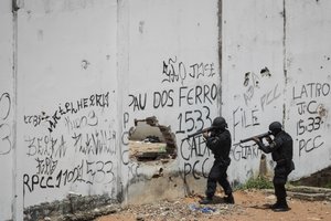 Special Operations Battalion Police officers enter the Alcacuz prison amid tension between rival gangs in Nisia Floresta, near Natal, Brazil, Saturday, Jan. 21, 2017.