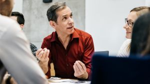 MAture man speaking in a business meeting.