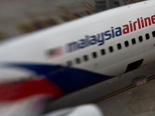 (FILES) This file photo taken with a tilt and shift lens on June 16, 2014 shows a Malaysia Airlines plane parked on the tarmac at Kuala Lumpur International Airport in Sepang. The official search for MH370 may have been called off but experts believe the missing airliner will one day be found, perhaps either by deep-sea miners or treasure hunters lured by a huge cash reward. After spending almost three years and 150 million USD on a deep sea hunt for the Malaysian passenger jet in the remote Indian Ocean off western Australia, top aviation investigators have been forced to admit they have come up with nothing. / AFP PHOTO / MANAN VATSYAYANA / TO GO WITH Australia-Malaysia-China-MH370-aviation,FOCUS by Glenda KWEK