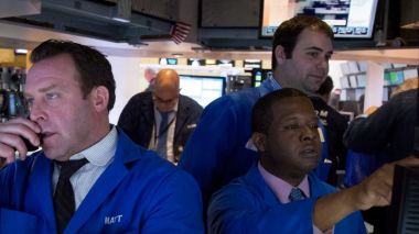 Traders work on the floor of the New York Stock Exchange (NYSE) in New York, U.S., on Monday, Feb. 8, 2016. U.S. stocks ...