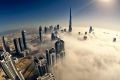 Dubai’s skyscrapers pierce low cloud.
