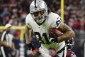Oakland Raiders tight end Mychal Rivera drives as Houston Texans free safety Andre Hal (29) defends during the second ...