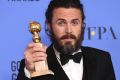 Casey Affleck poses in the press room with the Golden Globe award for his performance in 'Manchester by the Sea'. 