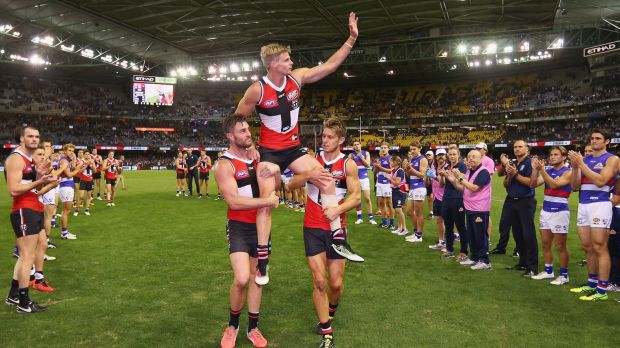 Nick Riewoldt of the Saints is carried off by teammates Sam Fisher and Sean Dempster after his 300th match.