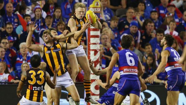 James Sicily of the Hawks rises above a pack to mark