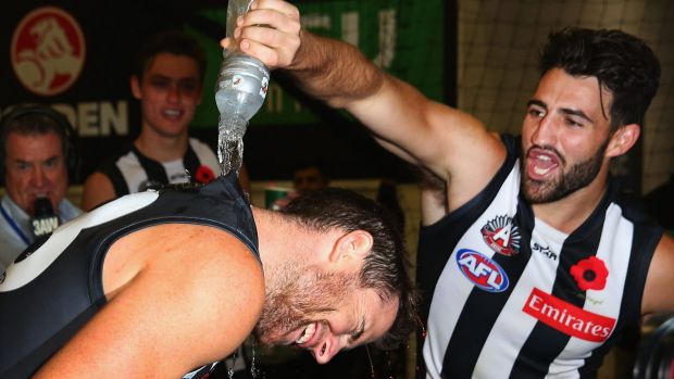 Jeremy Howe and Alex Fasolo celebrate in the room's after the game.