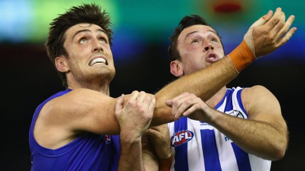 Eyes up: Tom Campbell of the Bulldogs and Todd Goldstein of the Kangaroos wait for the ball to descend.