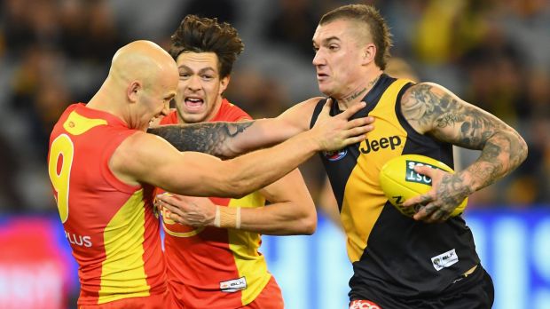 Don't argue: Richmond's Dustin Martin fends off Gold Coast skipper Gary Ablett.