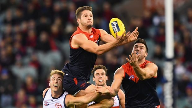 High-flyer: Demon Jesse Hogan throws himself at the football.