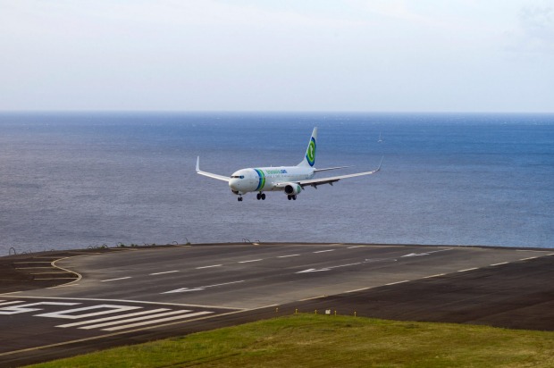 MADEIRA, PORTUGAL. The runway sits close to the sea at the base of a long sloping hill that generates powerful ...