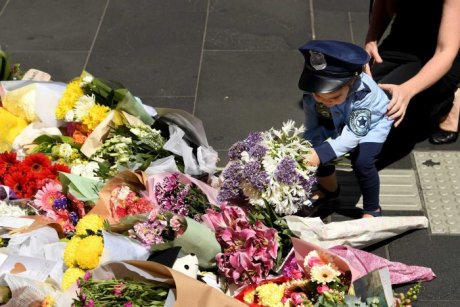 Mourners lay flowers (ABC News)