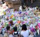 Tragic loss: The public lay flowers at Bourke street.