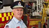 FRNSW Commissioner Greg Mullins stands in front of a fire truck